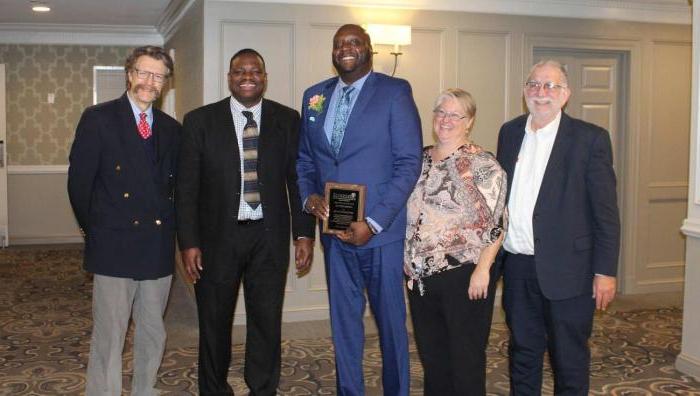 At left, Springfield College Professor of Social Work Miguel Arce, former Springfield College Department of Graduate Social Work Assistant Director of Field Education Sharlene Kerelejza, Master of Social Work student Carlton J. Smith, Springfield College Associate Professor of Social Work Anthony Hill, and Springfield College Chair for the Department of Graduate Social Work William T. Fisher.